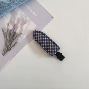 Close-up of blue and white checkered fabric duckbill hair clip with matte black metal tail