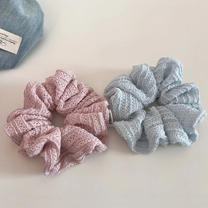 Lace hollow scrunchies in pink and blue colors with delicate woven texture and ruffles