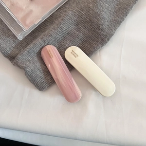 Close-up of pink marble and cream acetate hair clips with France Handmade engraving