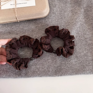 Set of two vintage leopard print oversized scrunchies in dark brown on a gift background