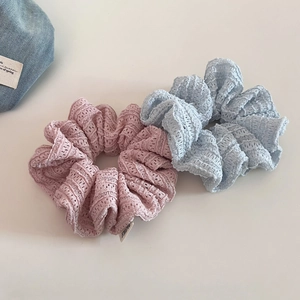 Detailed texture of hollow lace hair scrunchies in dusty pink and light blue colors