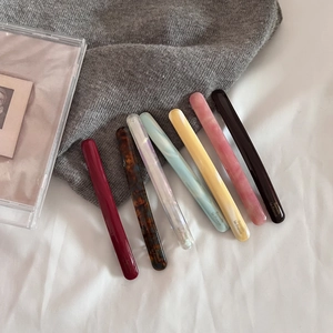 Detailed collection of 7 colorful acetate hair barrettes in marble patterns and shell finish