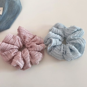 Detail shot of two sweet hollow lace scrunchies in soft Morandi pink and misty blue