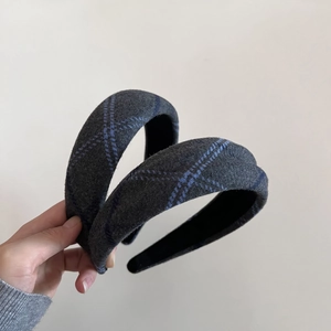Detail of grey plaid wool headband with padded sponge for a high top hair look