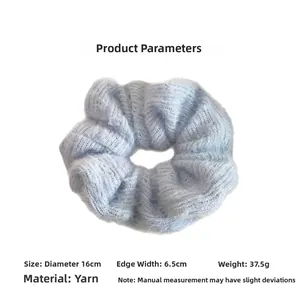 Detail showing soft light blue knitted hair scrunchie texture with 16cm diameter dimensions
