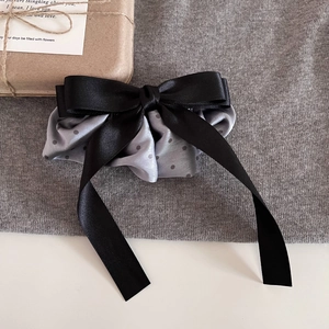 Polka dot satin scrunchie with long black ribbon bow hair clip for elegant hair styling