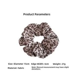 Detail view of leopard print hair scrunchie showing 15cm diameter and 6cm width dimensions