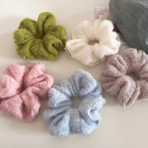 Five-pack set of colorful mohair-style knit scrunchies in pastel tones with logo tag