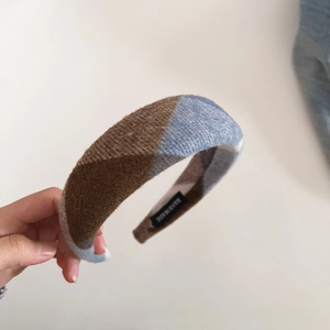 Close-up of handmade retro plaid wool hairband showing thick sponge padding and texture