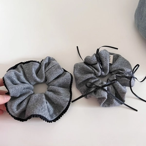 Elegant grey knitted scrunchies with black bow ties and handmade labels for women