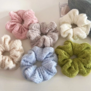 Set of 6 fuzzy knit scrunchies in pastel colors for gentle hairstyles on white background