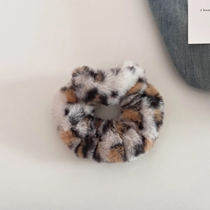 Close-up of leopard print faux fur scrunchie with soft plush texture for hair styling