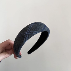 Detail of grey wool plaid headband with thick non-slip black inner lining for winter fashion