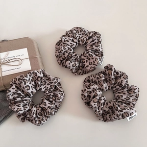 Three-piece set of leopard print knit hair scrunchies with white woven tags and gift box