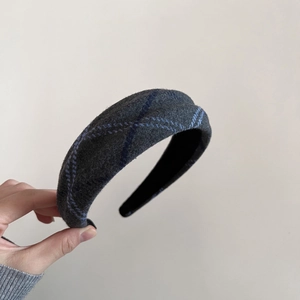 Detailed view of the dark grey plaid wool texture and soft fabric of the wide headband