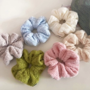 Close-up of soft knit hair scrunchies in six pastel colors for autumn and winter styles
