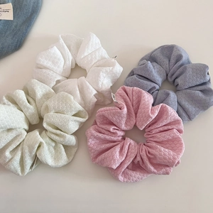 Set of four pastel bubble knit scrunchies in white, green, pink, and blue colors