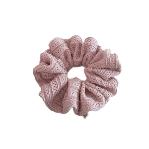 Pink lace hollow knit scrunchie for hair with a soft texture and brand label detail