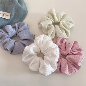 Set of four pastel bubble knit hair scrunchies in cream, purple, pink and green tones