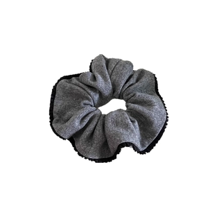 Gray knitted scrunchie with black pleat trim and bow design for winter hairstyles