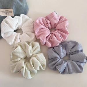 Set of four bubble knit hair scrunchies in pastel colors with soft textured fabric