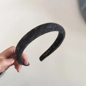 Close-up of charcoal gray knitted sponge headband with padded high-top design