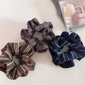 Three-piece set of knitted striped scrunchies in brown, gray, and navy blue tones