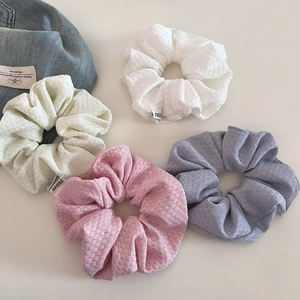 Set of four textured knit hair scrunchies in pastel colors with honeycomb fabric detail