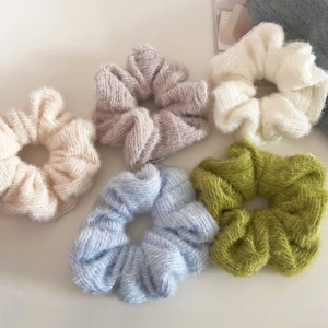 Set of five soft knit scrunchies in pastel colors for gentle autumn and winter hairstyles