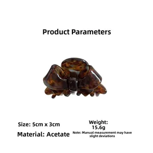 Detail view of tortoiseshell acetate bow hair claw clip measuring 5cm by 3cm