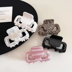 Detailed set of five acetate hair claws in various patterns like leopard and tortoiseshell