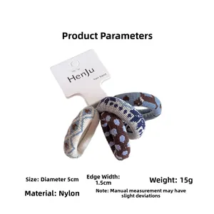 Detailed size view of four polka dot elastic hair ties with 5cm diameter and nylon fabric