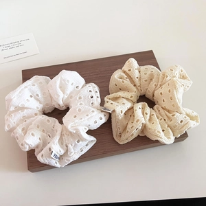 Set of two hollow lace scrunchies in white and cream colors for a sweet ponytail style