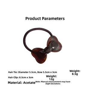 Detail view of brown tortoiseshell acetate bow hair tie with precise 5.5cm measurements