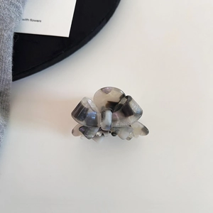 Elegant bow hair claw in grey marble acetate finish for stylish half-up hairstyles