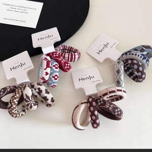 Detail of high elastic knitted hair bands set with polka dot and jacquard patterns