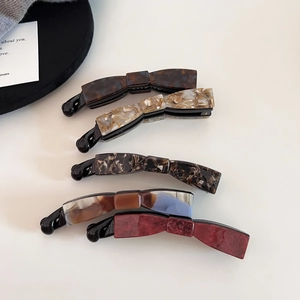 Elegant bow-shaped acetate banana hair clips in five vintage marble patterns for women