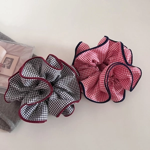Chic plaid oversized scrunchies in black and red patterns with contrasting border edges
