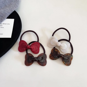 Set of four elegant bow hair ties in red, white and tortoiseshell acetate patterns