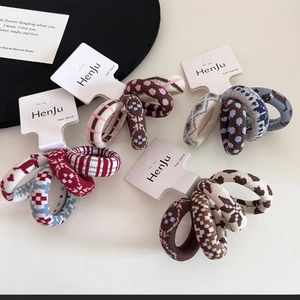 Detail of high-elasticity knitted hair bands featuring polka dots and checkered patterns