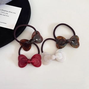 Set of four sweet acetate bow hair ties in red, pearl white, and tortoiseshell patterns