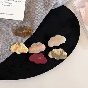 Detailed set of cloud-shaped acetate hair clips in tortoiseshell and marble finishes