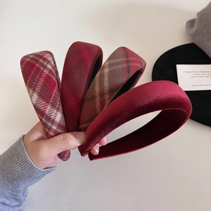 Close-up of vintage red plaid and velvet padded headbands with thick sponge design