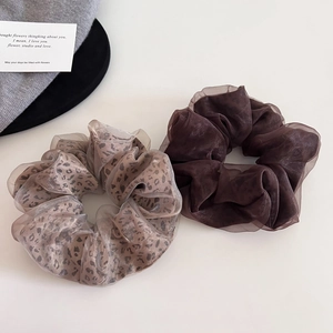 Detail view of mesh leopard print and coffee brown organza oversized hair scrunchies