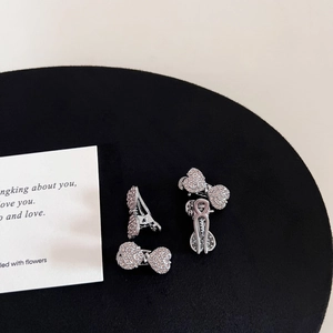 Detailed close-up of premium gunmetal hair clips with pink and white rhinestones