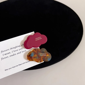 Detail of cloud-shaped acetate hair clips with silver France Handmade engraving