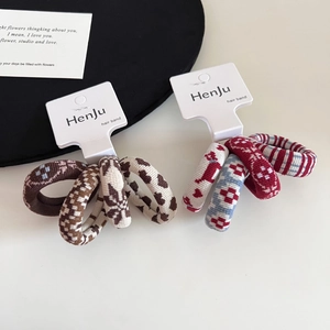 Detailed close-up of knitted dot puppy jacquard hair ties in autumn and winter colors
