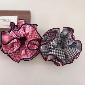 Plaid oversized scrunchies set in red and black checkered patterns with contrast edges