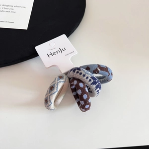 Detailed close-up of 4-pack elastic knitted hair ties with polka dot and puppy patterns