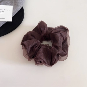 Detail of elegant dark brown mesh scrunchie with a shimmering pearlescent finish